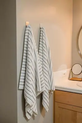 two towels hanging on a wall in a bathroom at Upscale Modern Spacious Loft in Little Italy in San Diego