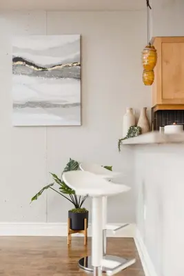 a kitchen with a white table and a potted plant at Upscale Modern Spacious Loft in Little Italy in San Diego