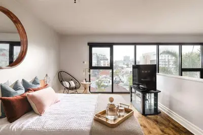 a bedroom with a bed and a large window at Upscale Modern Spacious Loft in Little Italy in San Diego