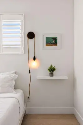 a white bedroom with a lamp next to a bed at Inviting 3BR Near Mission Beach in San Diego