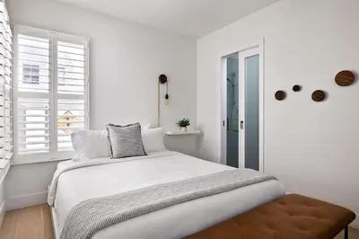 a white bedroom with a bed and a window at Inviting 3BR Near Mission Beach in San Diego