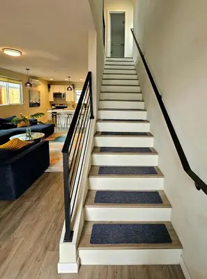 a staircase in a house with a living room at Heights Golden Luxe Retreat in San Diego