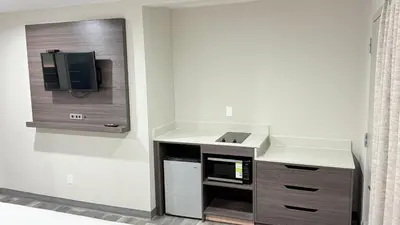 a kitchen with a microwave oven and a sink at Broadway Inn and Suites in Chula Vista