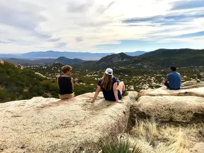 a group of people sitting on top of a rock at Unique Western-Themed Cabin Rental for Secluded Getaway in Warner Springs, California in Warner Springs
