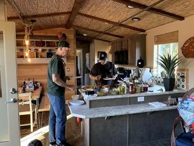two men standing in a kitchen preparing food at Unique Western-Themed Cabin Rental for Secluded Getaway in Warner Springs, California in Warner Springs