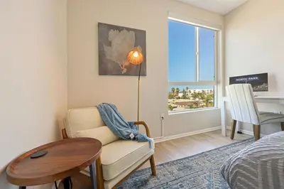 a bedroom with a bed and a table and a chair at Lux North Park Gem King Beds Workspaces Parking in San Diego