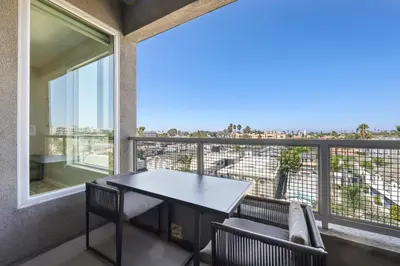 a table and chairs on a balcony with a view at Lux North Park Gem King Beds Workspaces Parking in San Diego