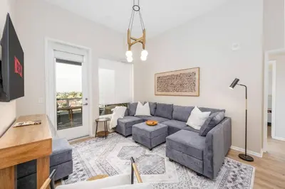 a living room with a couch and a tv at North Park Penthouse King Beds Workspaces Parking in San Diego