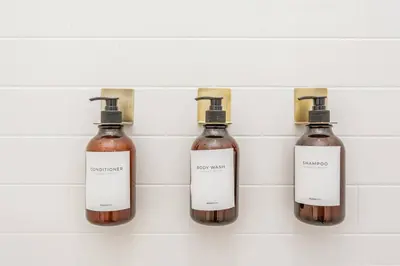 a group of three bottles of soap on a wall at North Park Penthouse King Beds Workspaces Parking in San Diego