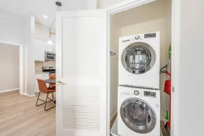 a laundry room with two washer and dryer at North Park Penthouse King Beds Workspaces Parking in San Diego