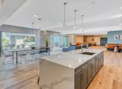a large kitchen and living room with a table and chairs at North Park Penthouse King Beds Workspaces Parking in San Diego