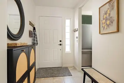 a hallway with a white door and a mirror at Carmel Valley 2BR with Amenities in San Diego