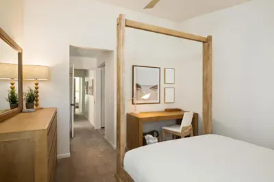a bedroom with a bed and a desk and a mirror at Carmel Valley 2BR with Amenities in San Diego