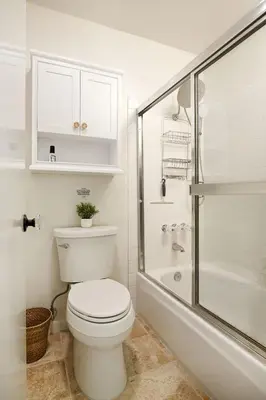 a white bathroom with a toilet and a shower at Carmel Valley 2BR with Amenities in San Diego