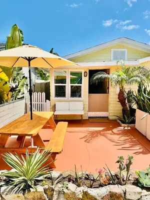 a house with an umbrella and a picnic table at Casa Luna in San Diego
