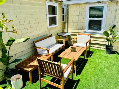 two chairs and a table on a patio with grass at Casa Luna in San Diego