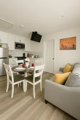 a kitchen and living room with a table and a couch at Terracotta Casita in San Diego