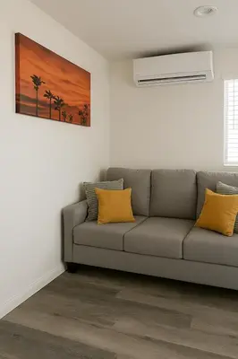 a living room with a couch and a painting at Terracotta Casita in San Diego