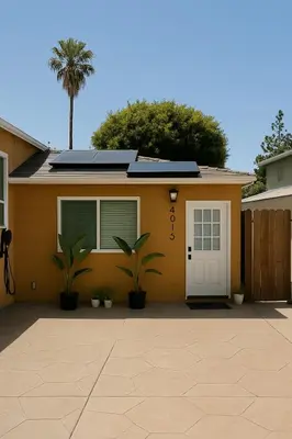 a house with a white door and a palm tree at Terracotta Casita in San Diego