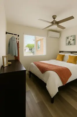 a bedroom with a large bed and a ceiling fan at Terracotta Casita in San Diego