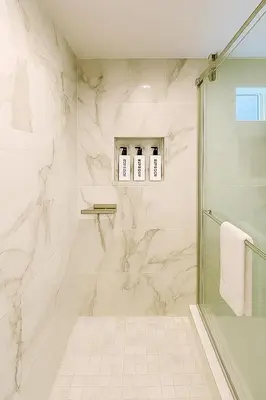 a bathroom with a shower and a glass shower stall at Terracotta Casita in San Diego