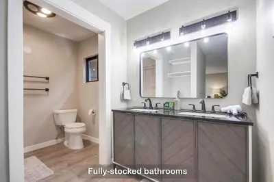 a bathroom with a sink and a toilet and a mirror at Entire Private Home with 3 Bedrooms 2 Bathrooms, Gated Yard, 100 inch TV, 1 Gbps WiFi, Available Now in San Diego