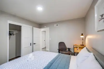 a bedroom with a bed and a chair at Entire Private Home with 3 Bedrooms 2 Bathrooms, Gated Yard, 100 inch TV, 1 Gbps WiFi, Available Now in San Diego