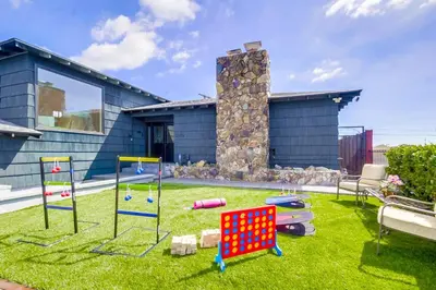 a yard with play equipment in front of a house at Entire Private Home with 3 Bedrooms 2 Bathrooms, Gated Yard, 100 inch TV, 1 Gbps WiFi, Available Now in San Diego