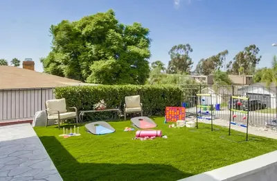 a yard with a playground with chairs and toys on the grass at Entire Private Home with 3 Bedrooms 2 Bathrooms, Gated Yard, 100 inch TV, 1 Gbps WiFi, Available Now in San Diego