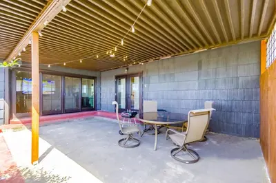 a patio with a table and chairs on it at Entire Private Home with 3 Bedrooms 2 Bathrooms, Gated Yard, 100 inch TV, 1 Gbps WiFi, Available Now in San Diego