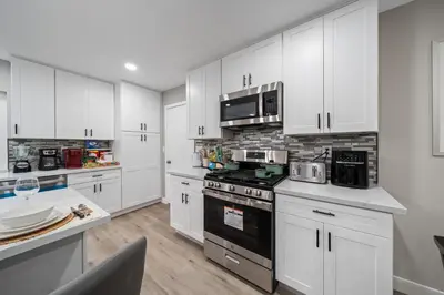 a kitchen with white cabinets and a stove top oven at Entire Private Home with 3 Bedrooms 2 Bathrooms, Hot Tub, Garage, King Bed, Available Now in Spring Valley