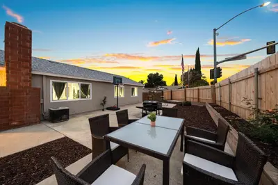 a patio with a table and chairs and a fence at Entire Private Home with 3 Bedrooms 2 Bathrooms, Hot Tub, Garage, King Bed, Available Now in Spring Valley