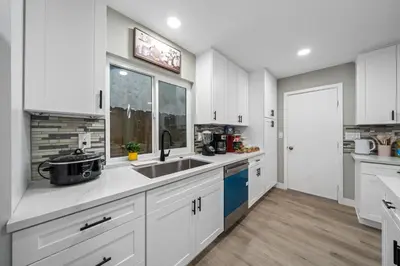 a kitchen with white cabinets and a sink at Entire Private Home with 3 Bedrooms 2 Bathrooms, Hot Tub, Garage, King Bed, Available Now in Spring Valley