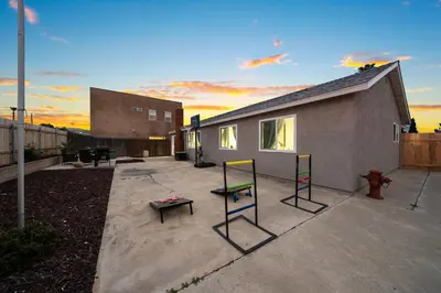 a patio with a house with a bench and a fire hydrant at Entire Private Home with 3 Bedrooms 2 Bathrooms, Hot Tub, Garage, King Bed, Available Now in Spring Valley