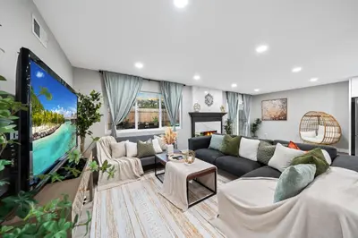 a living room with a couch and a tv at Entire Private Home with 3 Bedrooms 2 Bathrooms, Hot Tub, Garage, King Bed, Available Now in Spring Valley
