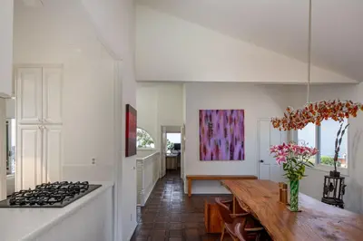 a kitchen with a table and a stove in a room at Bird Rock Dream - Pool, Spa, and Stunning Ocean View! in San Diego
