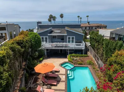 an aerial view of a house with a pool and umbrella at Bird Rock Dream - Pool, Spa, and Stunning Ocean View! in San Diego