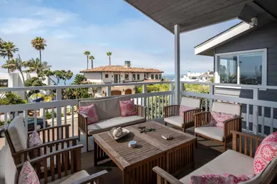 a patio with a table and chairs on a balcony at Bird Rock Dream - Pool, Spa, and Stunning Ocean View! in San Diego