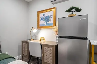 a desk and a refrigerator in a room at Entire Private Studio with 1 King Bed, Full Kitchen, Gated Yard, Available Now in Spring Valley