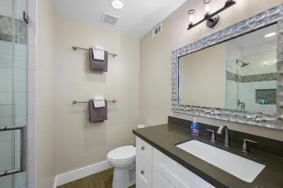 a bathroom with a sink and a mirror at Oceanview Steps to Beach AC Parking! in Newport Beach