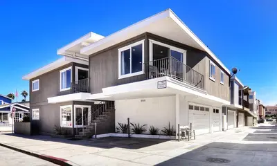 a large house with a lot of windows and a driveway at Oceanview Steps to Beach AC Parking! in Newport Beach