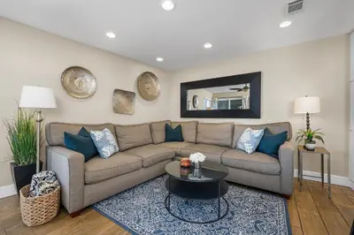 a living room with a couch and a table at Steps to Beach AC Parking Beach Equipment in Newport Beach