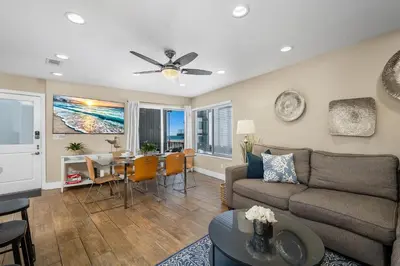 a living room with a couch and a table at Steps to Beach AC Parking Beach Equipment in Newport Beach