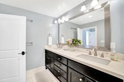 a bathroom with two sinks and a large mirror at Monthly 4BD4BA LuxuryHot TubPool TableYard in San Clemente