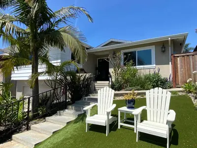two white chairs and a table in front of a house at Monthly 4BD4BA LuxuryHot TubPool TableYard in San Clemente