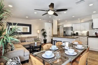 a kitchen and living room with a table and a couch at Steps to SandParkingACGround Level in Newport Beach