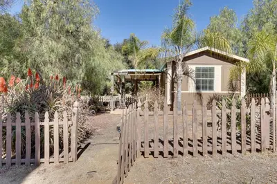 a wooden fence in front of a house at Hike, Explore and More Ranch Retreat in Escondido! in Valley Center