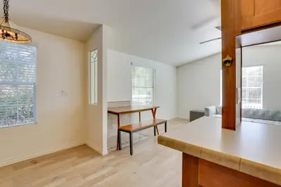 an empty living room with a table and a desk at Hike, Explore and More Ranch Retreat in Escondido! in Valley Center