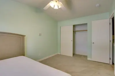 an empty bedroom with a bed and a ceiling fan at Hike, Explore and More Ranch Retreat in Escondido! in Valley Center