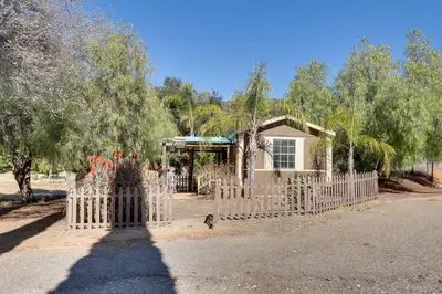 a white picket fence in front of a house at Hike, Explore and More Ranch Retreat in Escondido! in Valley Center
